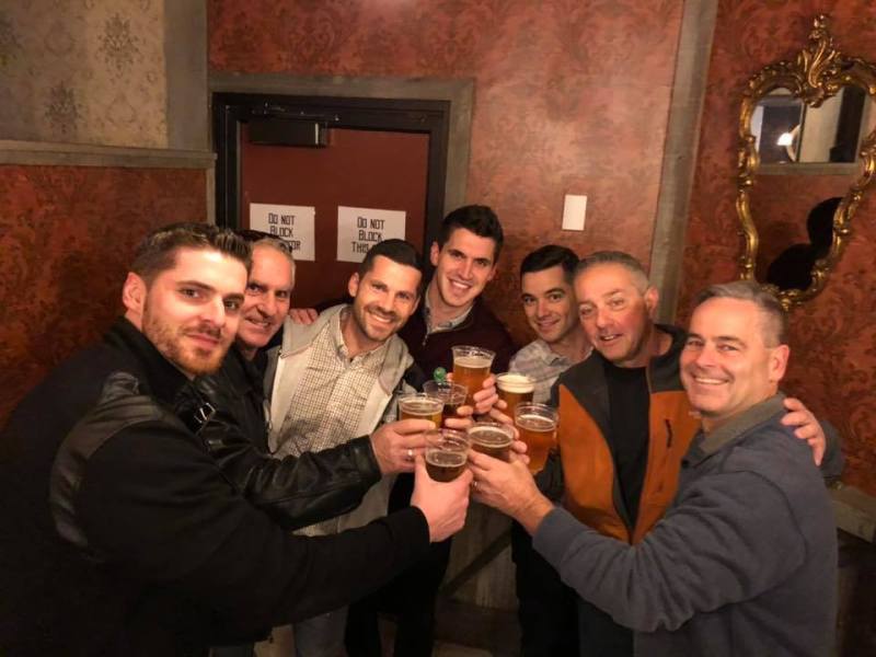 a group of people sitting at a table with wine glasses