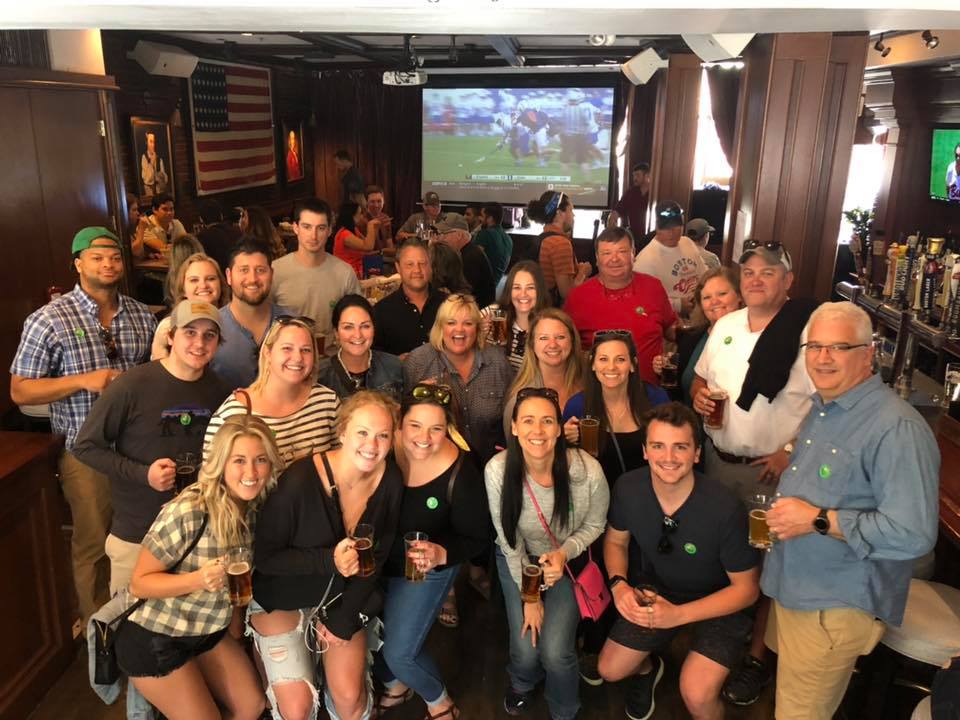a group of people standing in front of a crowd posing for the camera